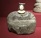 Female figurine of the "Bactrian princess" type; between 3rd millennium and 2nd millennium BC; grey chlorite (dress and headdresses) and calcite (face); Barbier-Mueller Museum