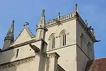 View of the square bell tower and front gables