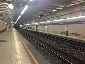 Platforms on both sides with a double track rail line going in the middle. Station signs reading Üçyol, the station name, and the exits, are visible.