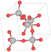 Unit cell of α-cristobalite; red spheres are oxygen atoms. We see here five silicon atoms in a helix (the first and the last are equivalent atoms in the lattice) going in the "c" direction (into the page). The horizontal and vertical axes are the "a" axes.