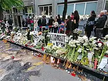 A group of citizens putting on candles at the school, following the school shooting