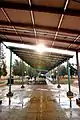 students seek shelter from rain under the solar energy plates