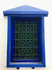 Image 46A window displaying a wrought iron window grill in Asila. The knots are tied with bent metal in the traditional way, rather than soldered. (from Culture of Morocco)