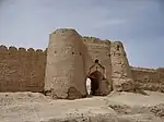 Ruins of buildings near a lake.