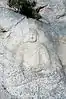 Seated stone Buddha statue Carved on the Rock at Yongjangsa temple site, Namsan Mountain in Gyeongju, Korea