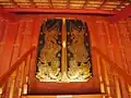 The beautiful lai rot nam (gilded black lacquer) door panels of the sala kan parian