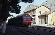 Thessaly Metre gauge system in central Greece from Volos to Kalabáka (or Kalambaka) was covered during a visit to the country in November 1992. Having spent the night here, the first move on 7 November 1992 was retracing our route as far as the junction station of Paleofarsalos. Seen here is German-built 2-car DMU no. A.6522 on train 1845, 09:40 Kalambaka to Volos. Note the rock formations in the background, which are a major tourist attraction in the area.