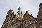 A sculpture on the façade of the English House (left) in Gdańsk was reconstructed by the artist at the beginning of the 1980s