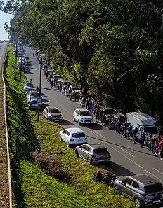 A surviving grocery store's queue reaches 800m long shortly after reopening.