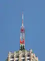 An antenna tower 146 feet (45 m) tall in San Antonio, TX with its red and white aircraft warning paint visible