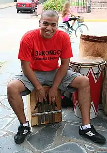 Afro-Argentine man playing a quisanche for candombe