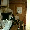 1960. Interior of the old Steibergdalshytten seen from the living room with the open fireplace, unchanged since 1895 when the cabin was erected. The door leads into one of the two bedrooms.