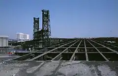 Photograph showing a lattice of steel girders on the Glisan Street ramp of the 1912 Steel Bridge, in Portland as redecking work is under way