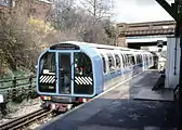 The Blue 1986 prototype London Underground train arriving at South Ealing station on the test track whilst undergoing trials.