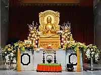 A replica of the Buddha Preaching his First Sermon sculpture, located in the modern Mulagandha Kuty Vihara