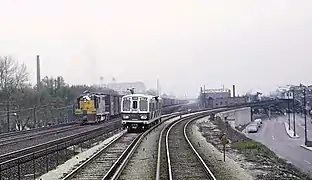 The transition from embankment to elevated over Lake Street in 1967. The C&NW freight train is at left.