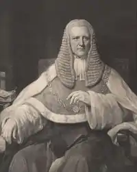 A black-and-white photograph of John Coleridge. He is wearing justice's robes, a gold chain around his sholders, and a large ruffled wig.