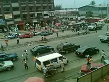 A picture of the Port Harcourt City centre from a highway with traffic and high rises in the distance