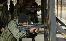 Operators from 1st SFG (A) train with an Indian Para SF armed with a IWI Tavor.