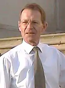 Nicholas Serota, a man wearing a white shirt and a solidly colored tie