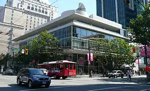 A glass-faced office building on a street corner