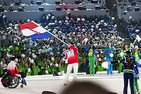 Athletes of Croatia entering during the opening ceremonies of the 2010 Winter Paralympics with the national flag.