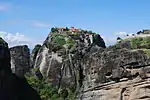 Rock pillars with buildings on top of some of them.