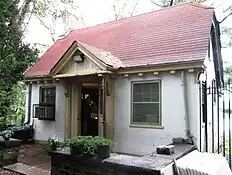 The cottage, a one-story structure with a red roof