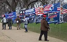 A row of flags supporting Donald Trump are lined on a lawn in D.C.