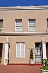 These five properties form an integral part of a row of nine double-storeyed Cape-Georgian terraced houses that were erected in 1886 by William James Hatfield. The corner shop units were added in 1901.