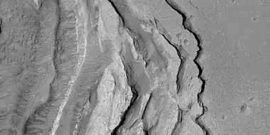 Tilted layers formed when ground collapsed, as seen by HiRISE, under HiWish program