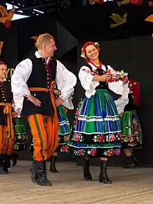 A man and woman wearing regional Łowicz-style folk dress in Poland