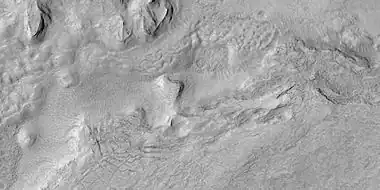 Surface breaking up, as seen by HiRISE under HiWish program as seen by HiRISE under HiWish program. Near the top the surface is eroding into brain terrain.