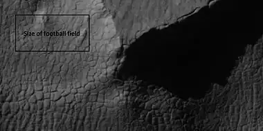 Close view of high center polygons near glacier, as seen by HiRISE under the HiWish program Box shows size of football field.