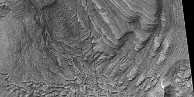 Tilted layers, as seen by HiRISE under HiWish program  Location is Hellas quadrangle.