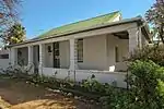 These six early Cape buildings from c.1830 have a history, scale and texture which is characteristic of Wellington, and they form an aesthetically pleasing group which contributes to its sensitive old town area.