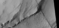 Close view of layers, as seen by HiRISE under HiWish program   A ridge cuts across the layers at a right angle.