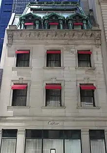 Detail of the Holbrook House facade, which contains a mansard roof above the limestone facade