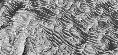 Close view of layers on floor, as seen by HiRISE.  Some faults are visible in image.