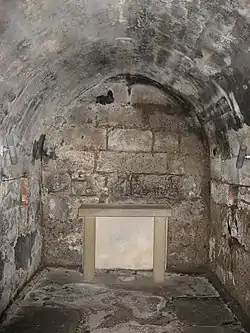 An underground stone lined crypt.