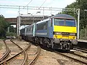 number 90006 passing Marks Tey railway station