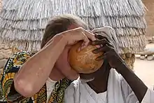 Friendship. Draining a gourd with millet beer together at the market, Mogodé, 1998.