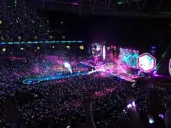 Stage lights are activated inside a darkened stadium