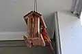 A male northern cardinal feeding on a bird feeder