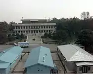 A 1988 photo of a truck in front of Phanmun Pavilion. The truck was part of a 50 truck caravan carrying 501 heads of cattle, which were a gift from Hyundai founder Chung Ju-yung to North Korea.