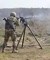 A soldier with the Ukrainian Land Forces fires a DShKM