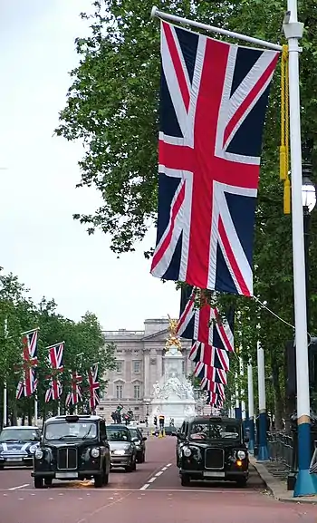 Image 55Union Flag being flown on The Mall, London looking towards Buckingham Palace (from Culture of the United Kingdom)