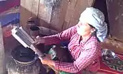 A woman extracting butter at the end of the process