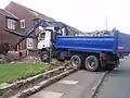 Truck with clamshell grab on arm, south Manchester, England, 27 July 2009