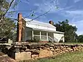 Another front view showing the historic stone wall.